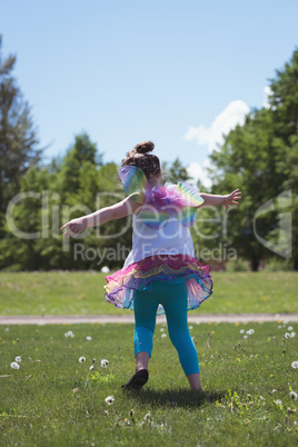 Rear view of girl playing in park