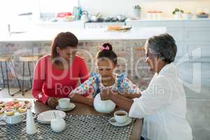 Happy multi-generation family having tea in dining table