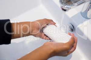 Girl washing hands in bathroom sink