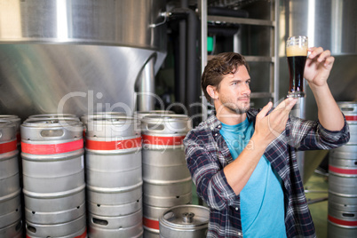 Worker examining beer at warehouse