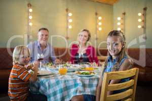 Portrait of happy family in restaurant