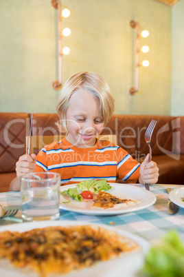 Boy having food in restaurant