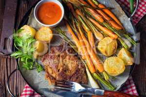 Grilled steak with vegetables and fried potatoes