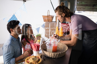 Customers giving order to waiter