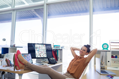 Female executive relaxing at her desk