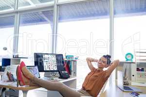 Female executive relaxing at her desk