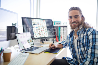 Portrait of male executive sitting at his desk