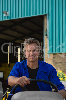 Portrait of worker driving a tractor