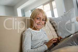 Boy using digital tablet in the living room at home