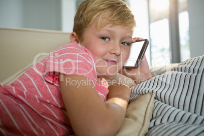 Boy talking on mobile phone in the living room