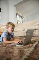 Boy using laptop in the living room