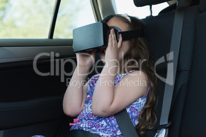 Little girl using virtual reality headset