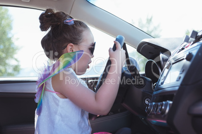 Girl pretending to drive a car