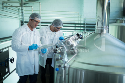 Scientists discussing at factory