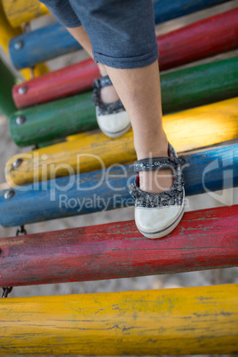 High angle view of girl walking on jungle gym