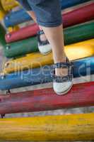 High angle view of girl walking on jungle gym