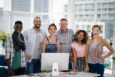 Team of executives standing together in the office