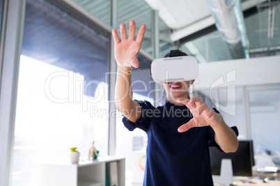 Female executive using virtual reality headset