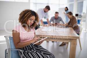 Female executive using digital tablet in the office