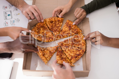 Close-up of executives sharing pizza