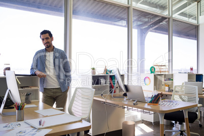 Male executive standing at his desk