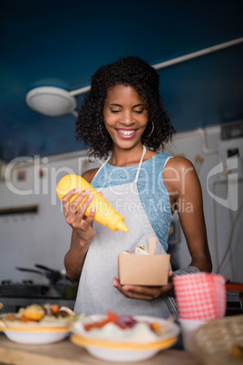 Waitress preparing meal for customer