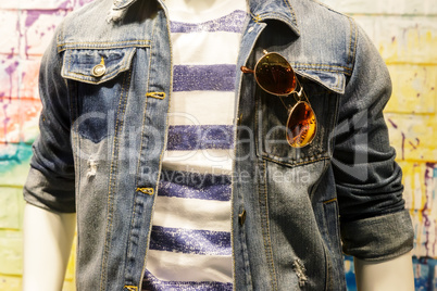 Clothes on the mannequin: jeans jacket, T-shirt, glasses.