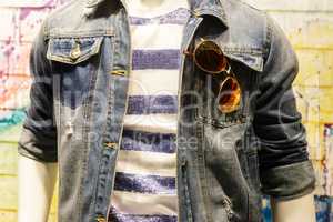 Clothes on the mannequin: jeans jacket, T-shirt, glasses.