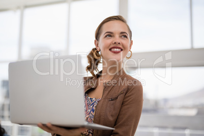 Female executive working on laptop in the office