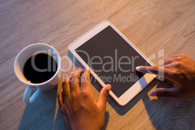 Male executive using digital tablet at his desk