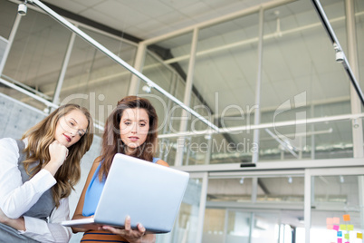 Female executives using laptop