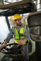 Worker driving a forklift car