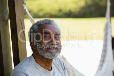 Senior man relaxing at the entrance of house