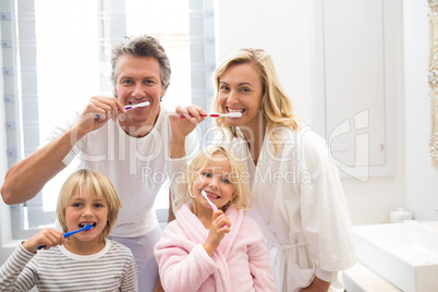 Family brushing teeth together in the bathroom