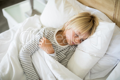 Boy sleeping on bed in the bedroom