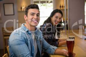 Portrait of smiling friends enjoying drinks at restaurant