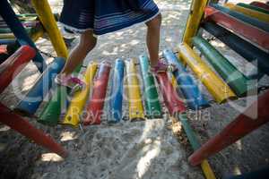 Girl walking on jungle gym