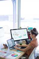 Female executive working over laptop at her desk