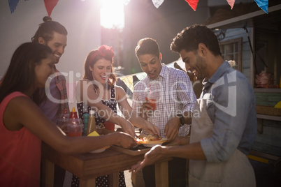 Waiter serving food to customers