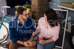 Couple interacting while having snacks and juice