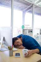 Male executive resting at his desk