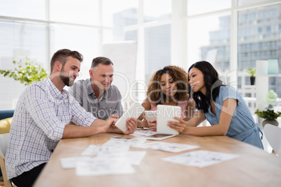 Team of executives using digital tablet in the office