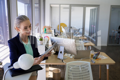 Female executive reading document at her desk