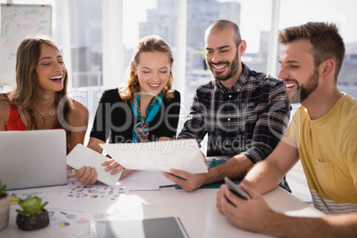 Business executives discussing over document paper