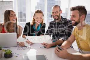 Business executives discussing over document paper
