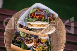 Meal and snacks in wicker basket at counter