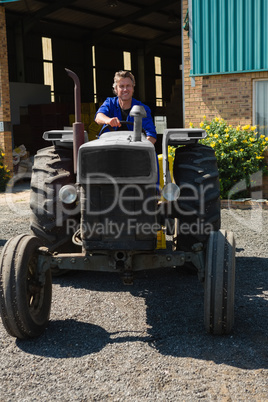 Attentive worker driving a tractor
