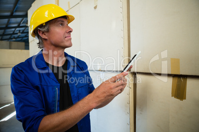 Worker maintaining record on digital tablet