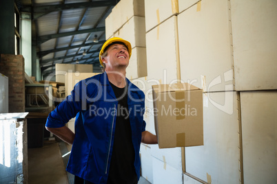 Worker standing with cardboard box