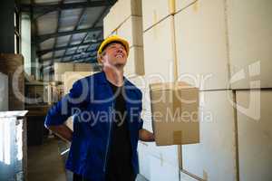 Worker standing with cardboard box